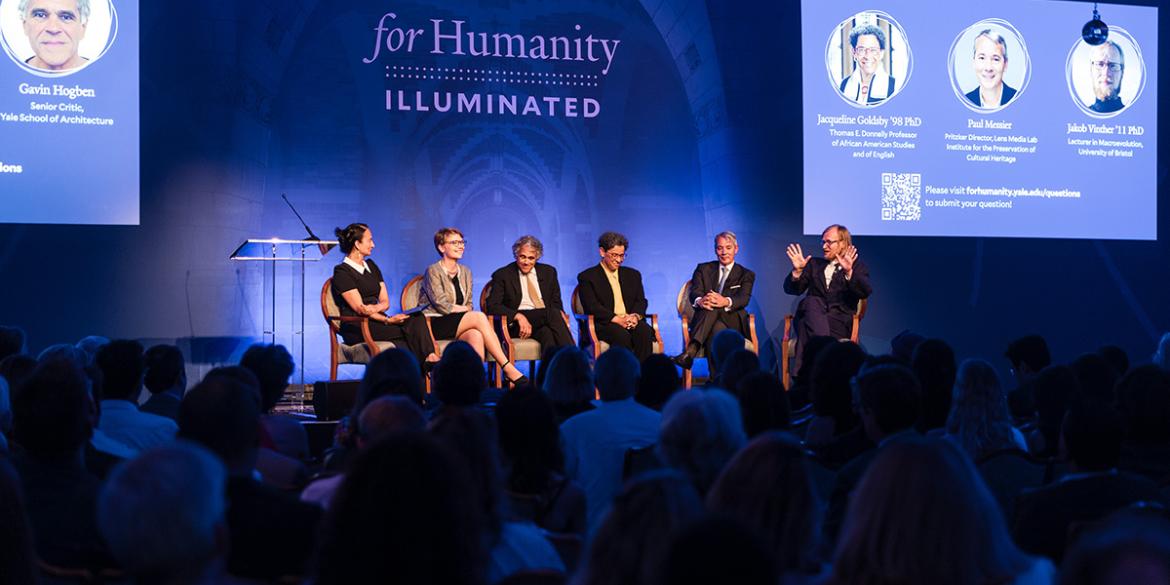 Panelists on stage at For Humanity Illuminated in London